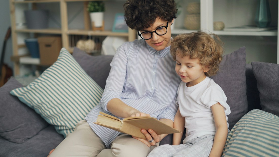 An adult and child enjoying a story together